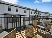 Thumbnail 34 of 46 - a patio with chairs and tables on a balcony