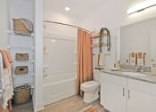 Thumbnail 38 of 46 - a bathroom with a shower and a sink and a toilet