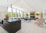 Thumbnail 41 of 46 - a kitchen with a large island and a living room with a table and chairs