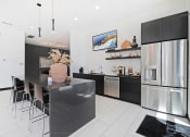 Thumbnail 12 of 46 - a kitchen with a large island and stainless steel appliances