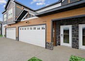 Thumbnail 1 of 26 - A modern house with a garage door and a stone wall.