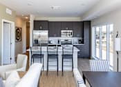 Thumbnail 25 of 46 - A modern kitchen with a white and black color scheme.