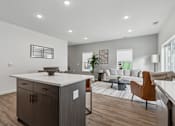 Thumbnail 7 of 26 - A modern kitchen with a wooden floor and a white countertop.