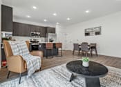 Thumbnail 8 of 26 - A modern living room with a brown leather chair and a black coffee table.