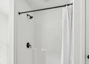 Thumbnail 18 of 26 - A white bathroom with a walk in shower.