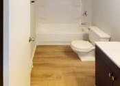 Thumbnail 35 of 46 - a bathroom with a toilet and a bath tub