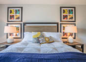 Thumbnail 34 of 46 - a bedroom with a bed and paintings on the wall