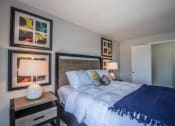 Thumbnail 32 of 46 - a bedroom with a bed and paintings on the wall