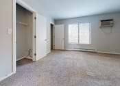 Thumbnail 27 of 46 - an empty room with a closet and a window