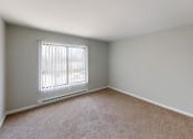 Thumbnail 26 of 46 - an empty bedroom with a window and carpet