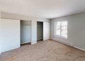 Thumbnail 24 of 46 - a bedroom with a large window and a closet