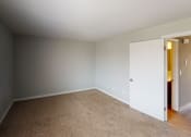 Thumbnail 25 of 46 - a empty room with a door to a closet