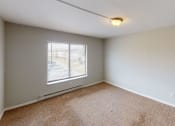 Thumbnail 22 of 46 - an empty living room with a window and carpet