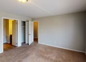 Thumbnail 21 of 46 - a bedroom with a large window and a carpeted floor