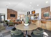 Thumbnail 20 of 27 - A modern dining room with a round table and chairs.