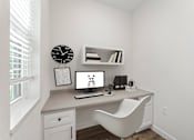 Thumbnail 4 of 27 - A white desk with a computer and a white chair in a room.