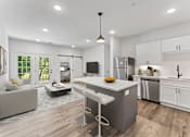 Thumbnail 1 of 27 - A modern kitchen with a white island and stainless steel appliances.