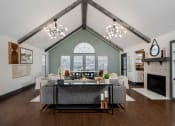 Thumbnail 24 of 40 - high ceiling club house with sofa and fireplace
