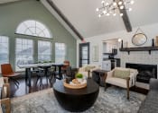 Thumbnail 26 of 40 - apartment club house lounge with large windows and kitchen