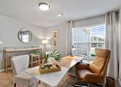 Thumbnail 4 of 9 - A modern dining room with a white table and chairs.