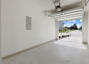 Thumbnail 14 of 19 - A white room with a window and a door leading outside.
