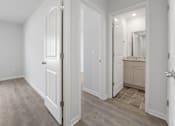 Thumbnail 8 of 19 - A white door is open to a bathroom.