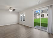Thumbnail 5 of 19 - A room with a ceiling fan and sliding glass doors.