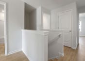 Thumbnail 7 of 19 - A white staircase with a landing in a house.