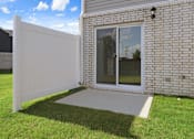 Thumbnail 19 of 19 - A white fence is in front of a brick house.