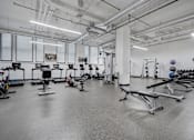 Thumbnail 19 of 32 - A gym with a variety of exercise equipment.