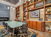 Thumbnail 28 of 32 - A conference room with a glass table surrounded by chairs.