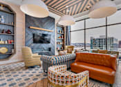 Thumbnail 22 of 32 - A living room with a fireplace and a view of the city.