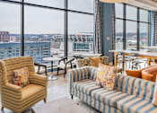 Thumbnail 23 of 32 - A living room with a view of a stadium.