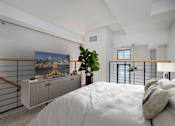 Thumbnail 8 of 32 - A bedroom with a bed, a cabinet, and a painting on the wall.