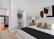 Thumbnail 3 of 32 - A bedroom with a large bed and a painting on the wall.
