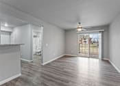 Thumbnail 8 of 23 - A spacious room with a sliding glass door leading to a balcony.