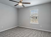 Thumbnail 11 of 23 - A room with a ceiling fan and a window with blinds.