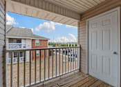 Thumbnail 20 of 23 - A white door is open to a deck with a railing.