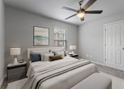 Thumbnail 2 of 23 - A bedroom with a large bed and a ceiling fan.