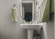 Thumbnail 17 of 33 - a small bathroom with a sink and a mirror