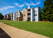 Thumbnail 28 of 29 - Apartment buildings with green lawns in front.