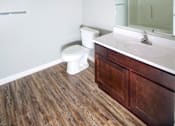 Thumbnail 7 of 29 - A white toilet sits next to a sink in a bathroom.