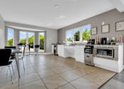 Thumbnail 8 of 29 - A kitchen with a black chair and a white counter.