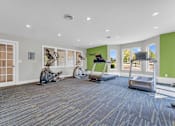 Thumbnail 13 of 29 - A room with a green wall and exercise equipment.