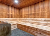 Thumbnail 16 of 29 - A room with wooden walls and a bench.
