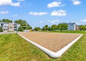 Thumbnail 21 of 29 - A large white pipe runs through a grassy field.