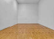 Thumbnail 14 of 29 - A wooden floor with white walls and a white ceiling.
