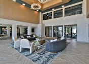 Thumbnail 12 of 38 - A spacious living room with a grey sofa and a wooden floor.