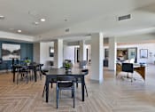 Thumbnail 16 of 38 - A spacious room with a dining table and chairs.