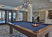 Thumbnail 17 of 38 - A pool table with a blue cloth and a set of balls on it.